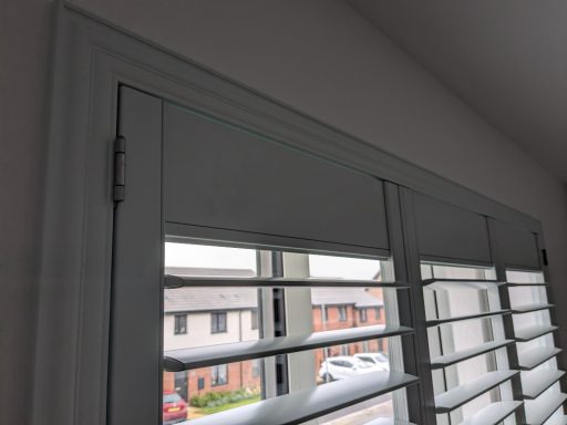 Custom fit shutters installed in a bedroom window on a Z frame