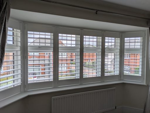 Modern living room with white window shutters