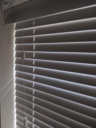 Real wood Venetian blind, closed, in a spare bedroom