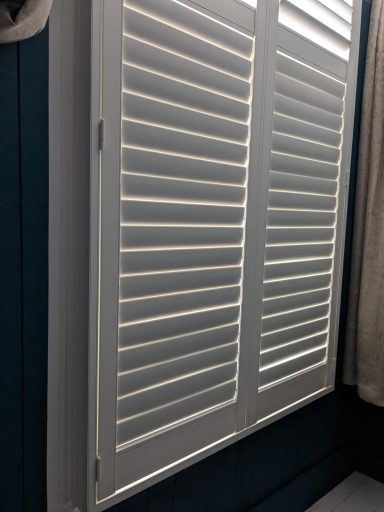 Modern living room with white window shutters