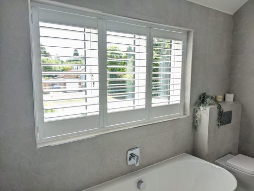 Modern white bathroom waterproof shutters installed for ease of cleaning and moisture resistance in UK