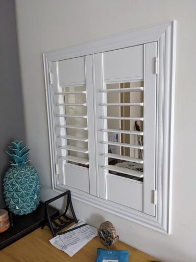 Traditional dining room with white shutters replacing serving hatch