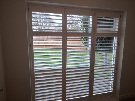 Modern living room with white window shutters