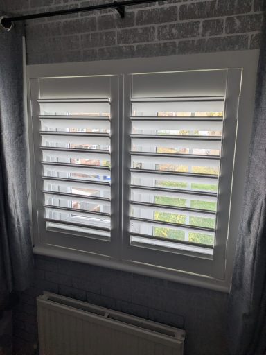 Modern living room with white plantation shutters