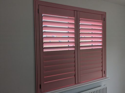 Modern dining room with pink window shutters