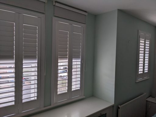 Modern living room with white window shutters
