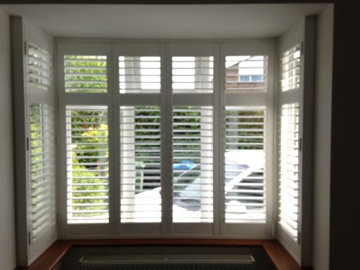 Modern living room with white window shutters