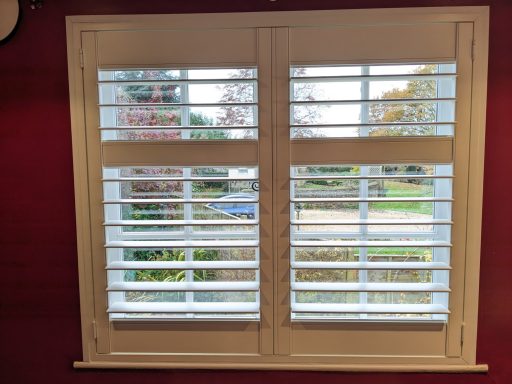 Modern living room with white window shutters