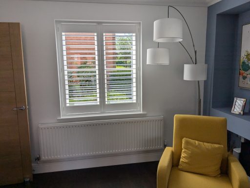 Modern living room with white window shutters