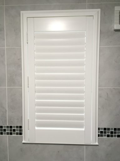 Modern living room with white window shutters