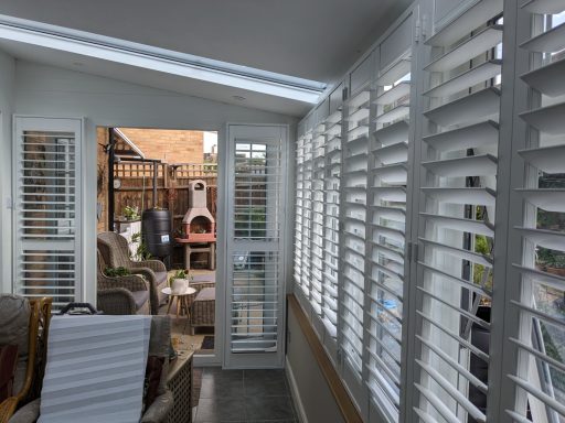 Modern living room with white window shutters