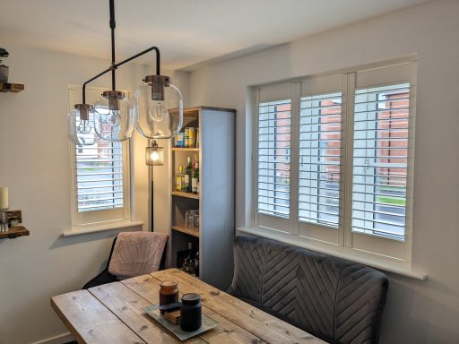 Modern living room with white window shutters