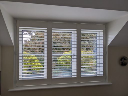 Shutters in white fitted in to a dormer window creating a seamless look