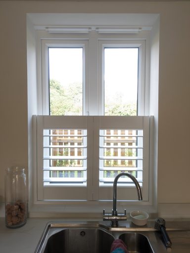 Modern living room with white window shutters